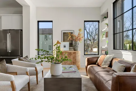 a living room with furniture and flowers