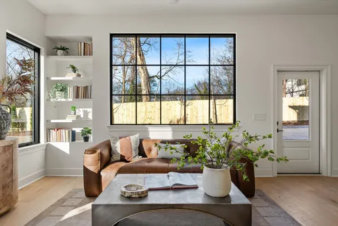 a kitchen with stainless steel appliances granite countertop a refrigerator a sink a stove and a wooden floors