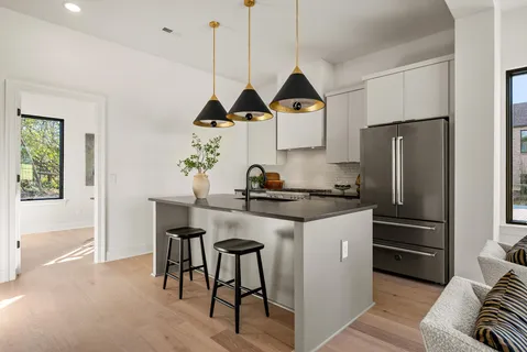a kitchen with stainless steel appliances granite countertop a stove and a refrigerator