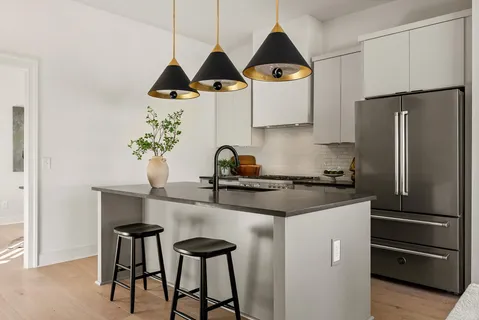 a kitchen with a sink and a refrigerator
