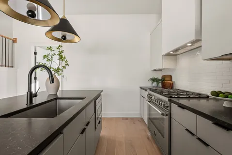 a bathroom with a granite countertop sink mirror vanity and toilet