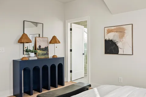 a living room with furniture and a potted plant