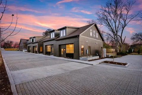 a view of a street with potted plants