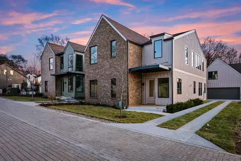 a view of a cafe with a lot of people on a road