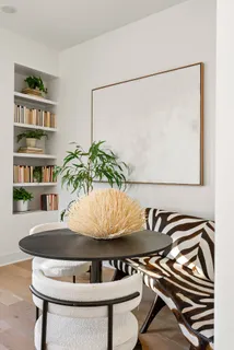 a living room with furniture fireplace and a large window