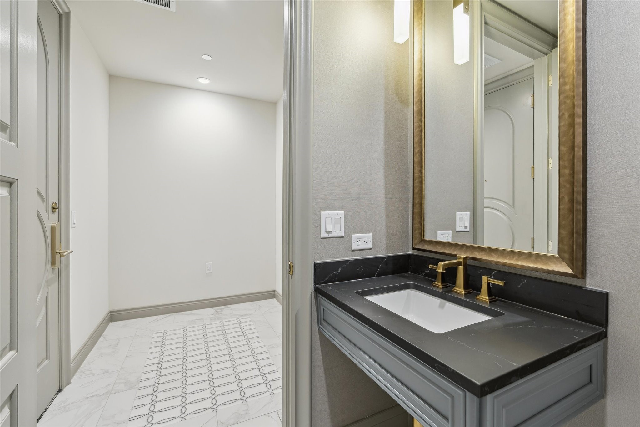 1717 Bissonnet Street, Unit 1604 Houston, TX 77005 - Photo 10 of 32 Half bathroom at the entry with designer wall coverings, Quartz counters and decorative lighting.