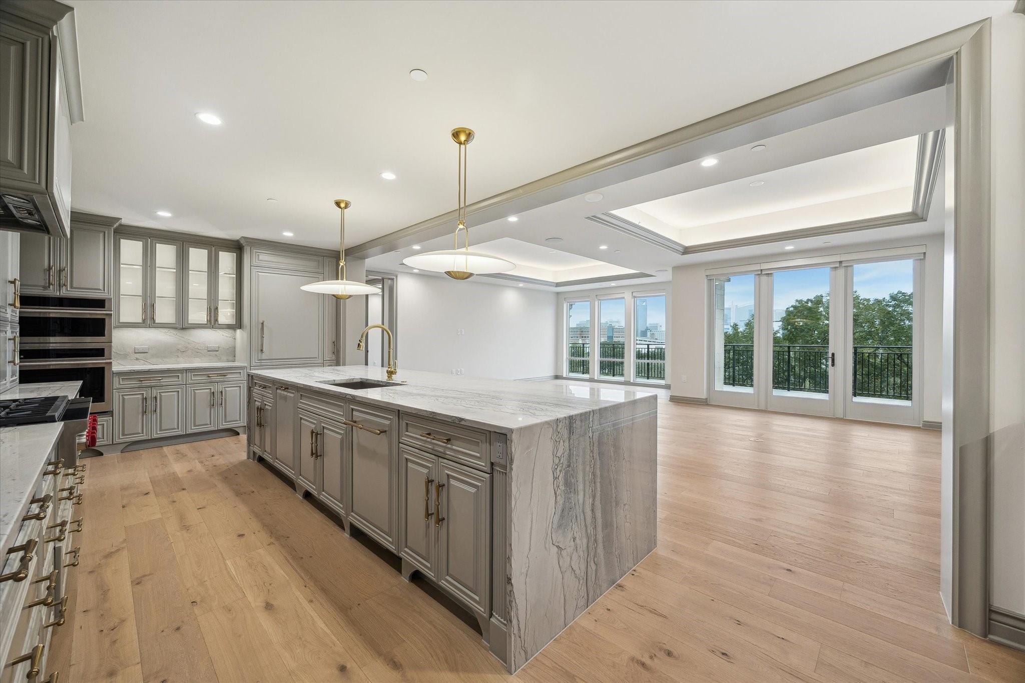 1717 Bissonnet Street, Unit 1604 Houston, TX 77005 - Photo 4 of 32 Beautiful wide plank hardwoods throughout, Quartzite waterfall island and counter tops, built-in panel front refrigerator and dishwasher.