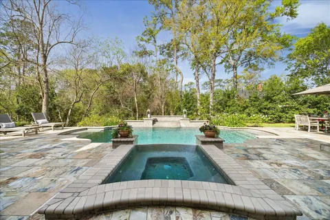 a view of backyard with swimming pool