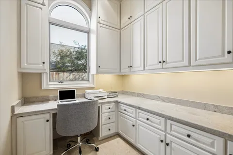 a kitchen with granite countertop a sink cabinets stainless steel appliances and a window