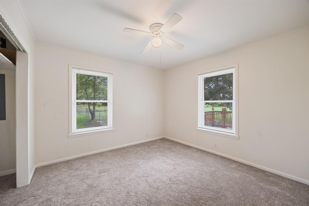 571 South 1st Street Point, TX 75472 - Photo 17 of 27 an empty room with a window and a ceiling fan
