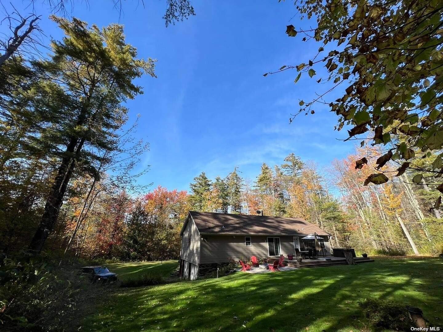 9 Pinekill Lane Windham, NY 12496 - Photo 17 of 27 a view of a big room with a big yard and potted plants and large tree