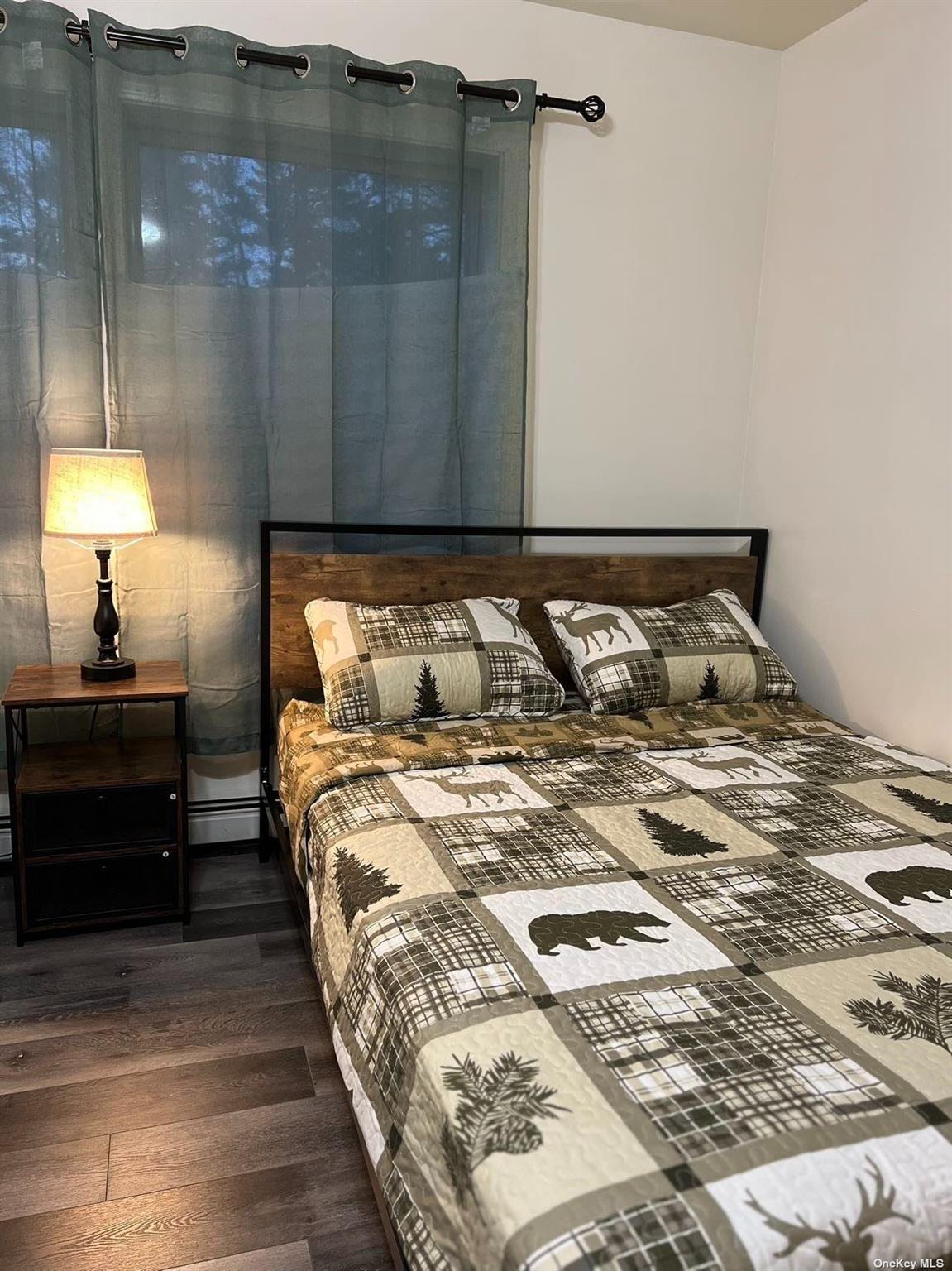 9 Pinekill Lane Windham, NY 12496 - Photo 6 of 27 a bedroom with a bed and a lamp