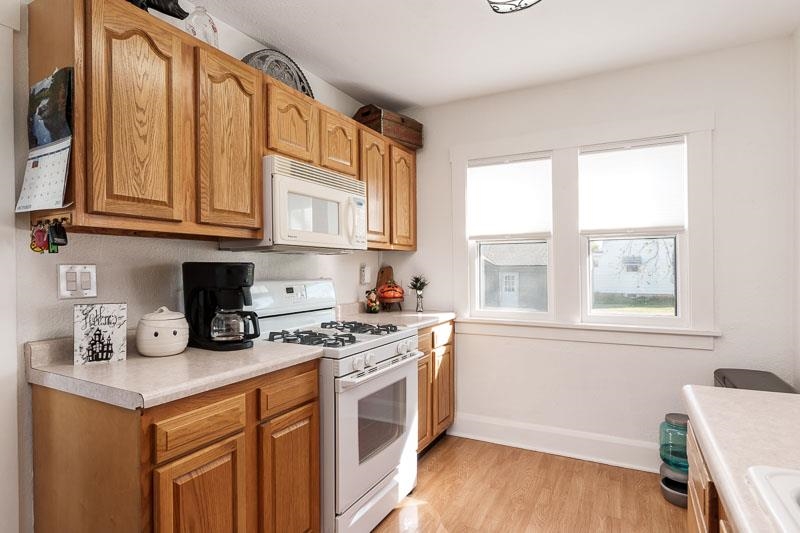 620 Harlem Road Machesney Park, IL 61115 - Photo 12 of 42 a kitchen with stainless steel appliances granite countertop a stove a sink and a microwave