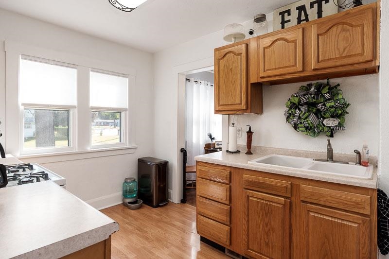 620 Harlem Road Machesney Park, IL 61115 - Photo 13 of 42 a kitchen with stainless steel appliances granite countertop a sink a stove and a wooden cabinets