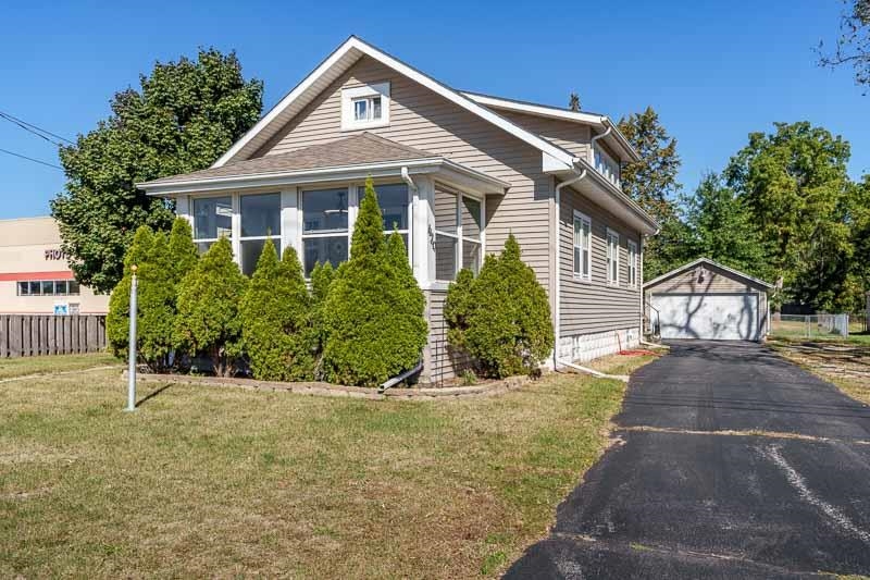 620 Harlem Road Machesney Park, IL 61115 - Photo 2 of 42 a front view of a house with a yard