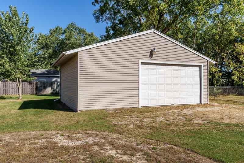 620 Harlem Road Machesney Park, IL 61115 - Photo 35 of 42 a backyard of a house with plants and large tree