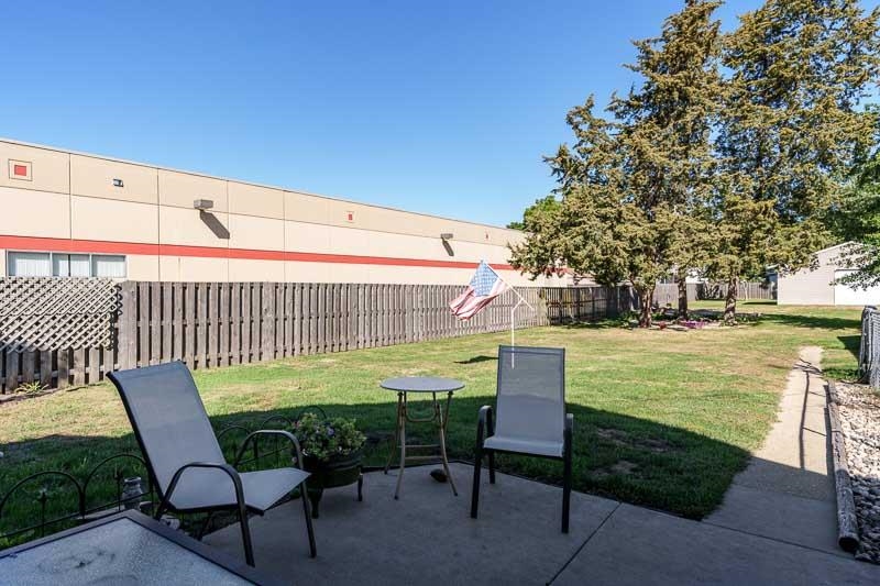 620 Harlem Road Machesney Park, IL 61115 - Photo 40 of 42 a view of a chairs and table in the patio with a lake view