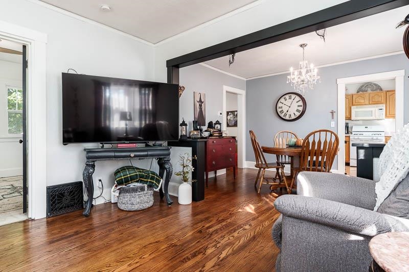 620 Harlem Road Machesney Park, IL 61115 - Photo 4 of 42 a living room with furniture a flat screen tv and a clock