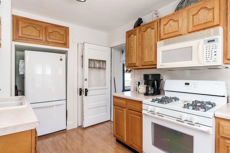 620 Harlem Road Machesney Park, IL 61115 - Photo 10 of 42 a kitchen with stainless steel appliances granite countertop a stove a refrigerator and a refrigerator with white cabinets
