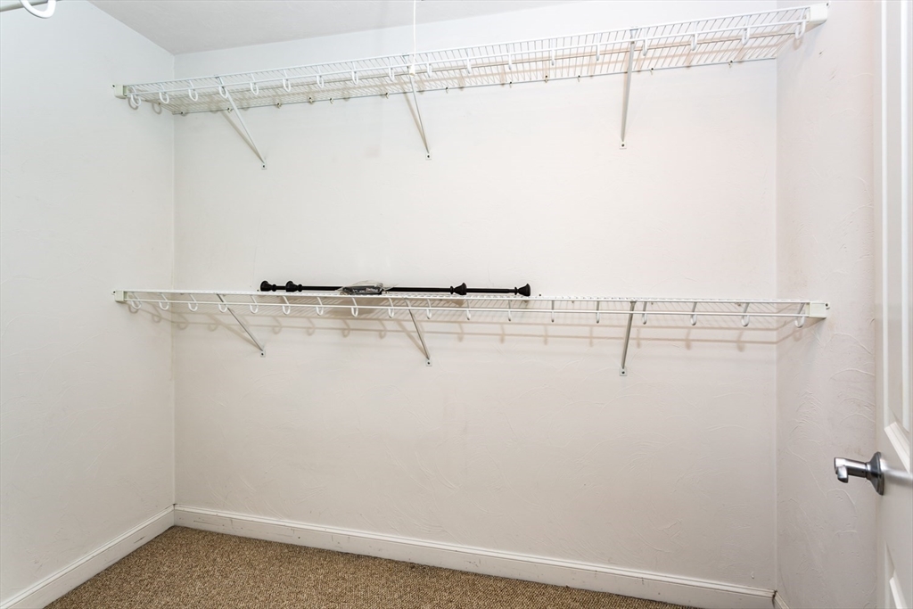 49 Beaver Street, Unit 49 Franklin, MA 02038 - Photo 20 of 46 a view of a room with racks on the wall