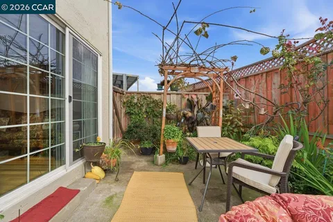 a view of a patio with a table and chairs and potted plants