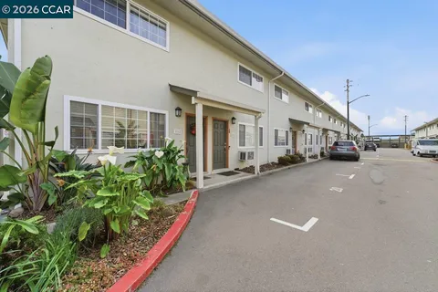 a couple of cars parked in front of a house