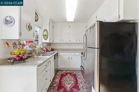a kitchen with a refrigerator and a sink