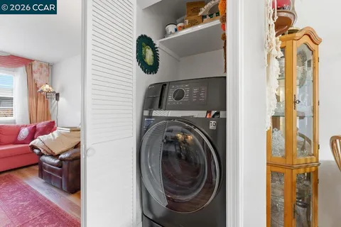 a view of a bedroom with washer and dryer