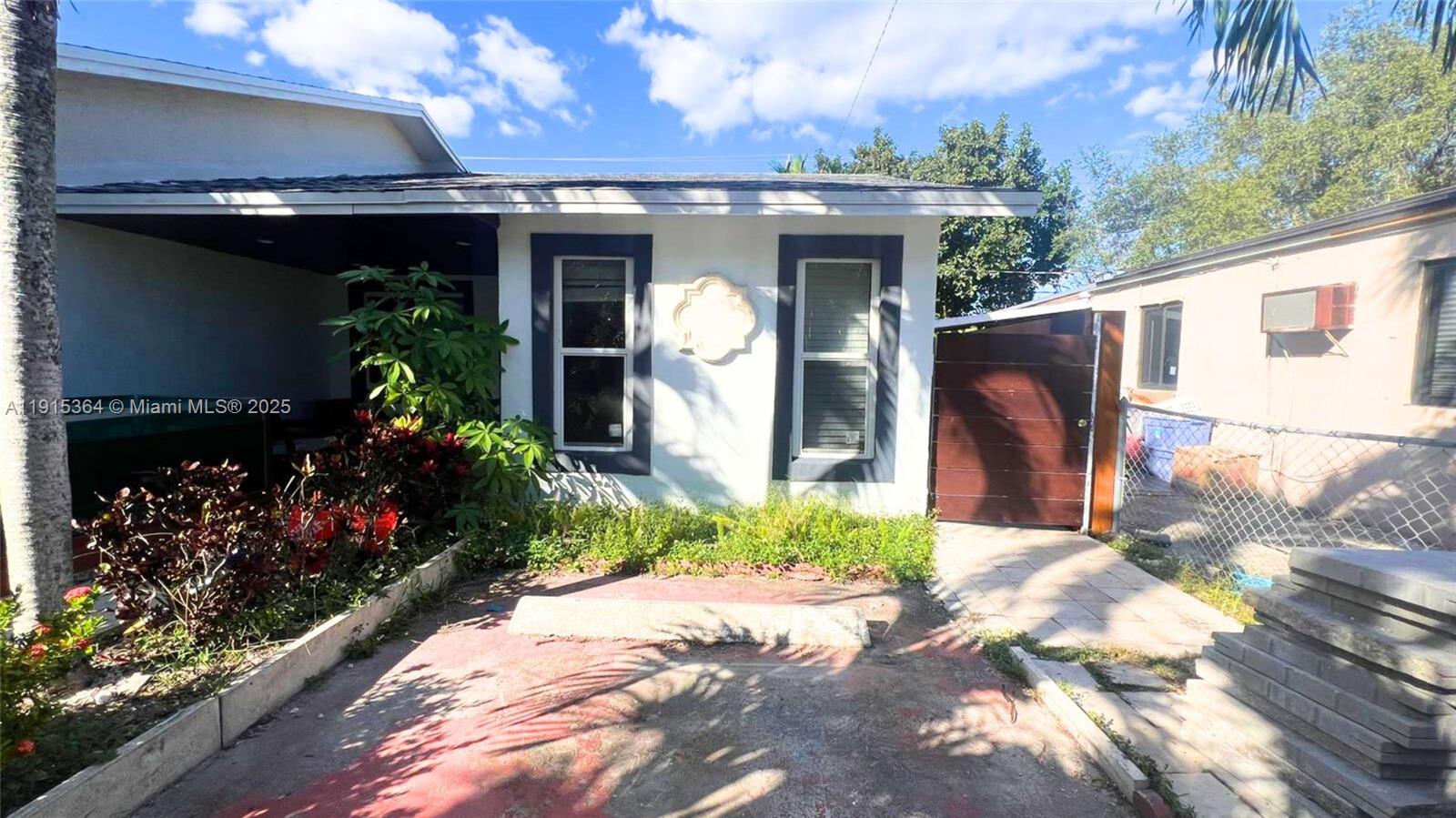 6481 Southwest 39th Terrace, Unit 2 Miami, FL 33155 - Photo 2 of 7 a front view of a house with a yard