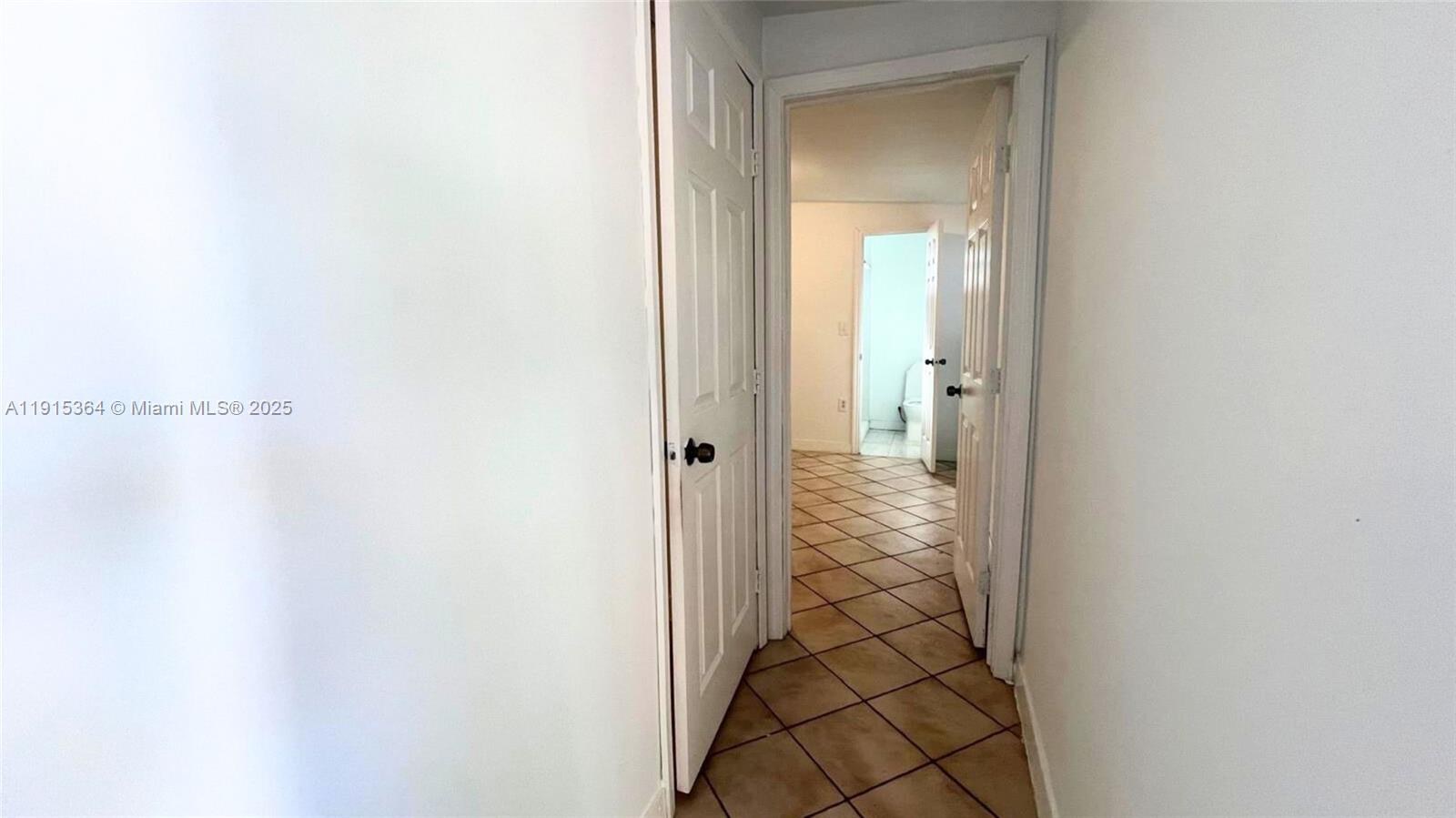6481 Southwest 39th Terrace, Unit 2 Miami, FL 33155 - Photo 6 of 7 a view of a bathroom from a corridor