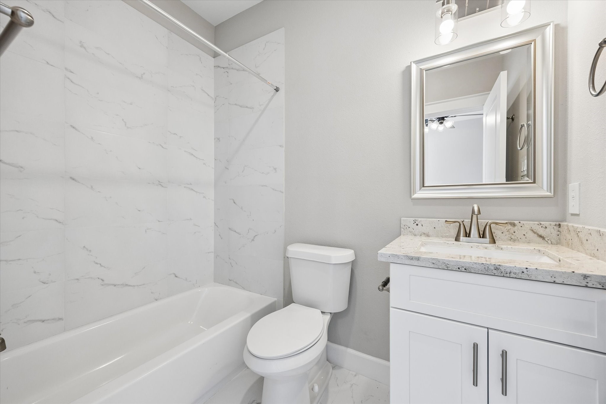 603 Link Road, Unit F Houston, TX 77009 - Photo 22 of 37 Secondary ensuite bath includes a tub and shower combination with a bright vanity area. A timeless, neutral palette keeps the space fresh and versatile.