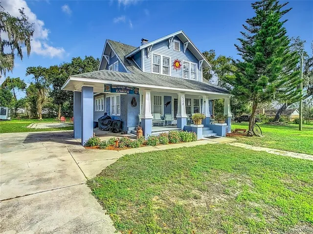 a view of a house with swimming pool and a yard
