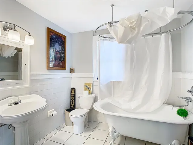 a bathroom with a sink mirror and toilet