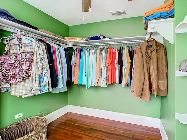 a view of walk in closet with clothes
