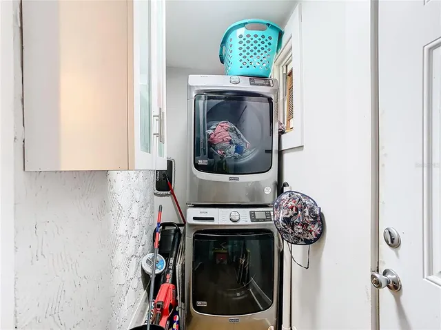a close view of a utility room with dryer and washer