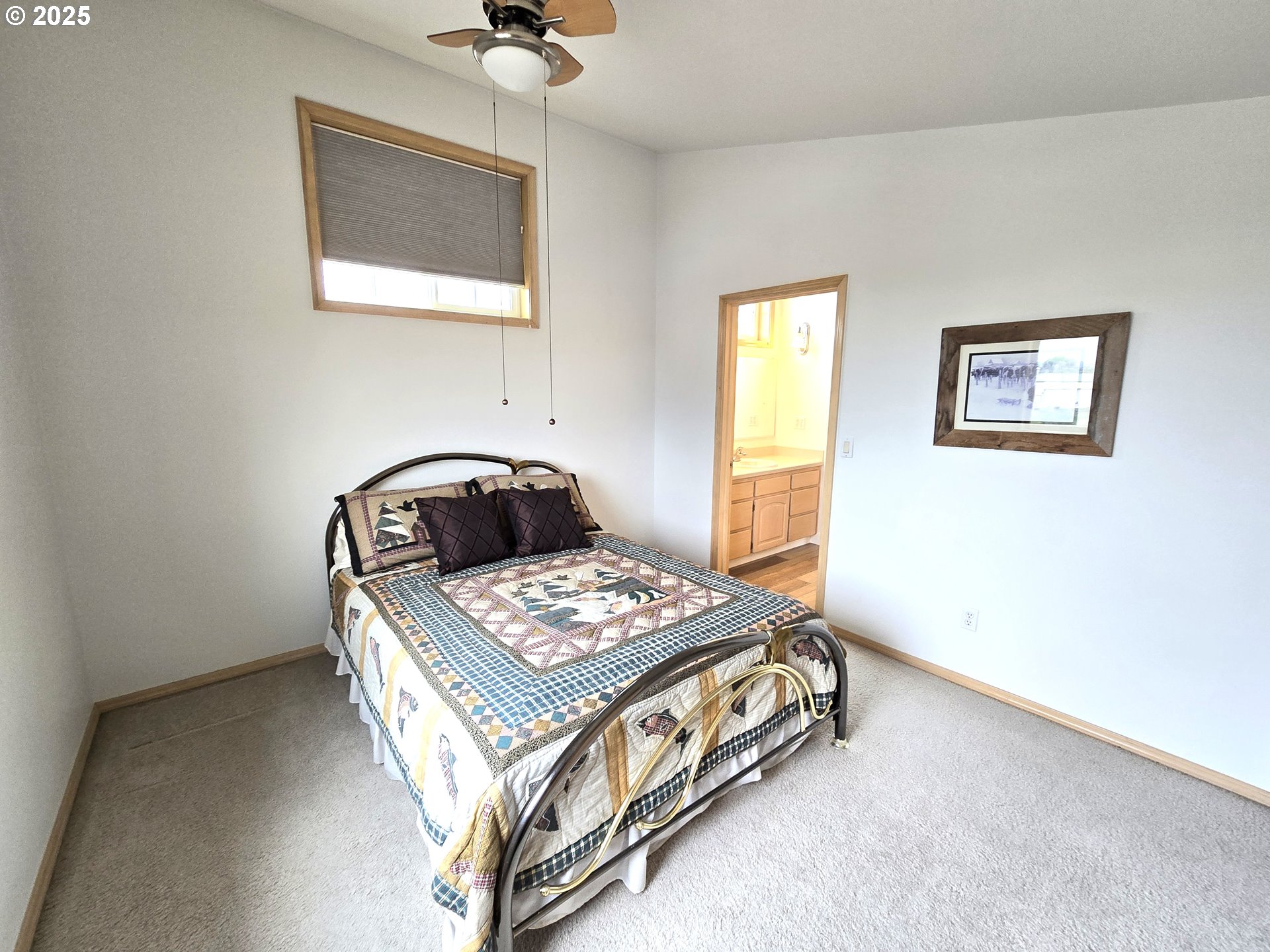 80393 Zimmer Lane Hermiston, OR 97838 - Photo 26 of 46 a bedroom with a bed and a table in it