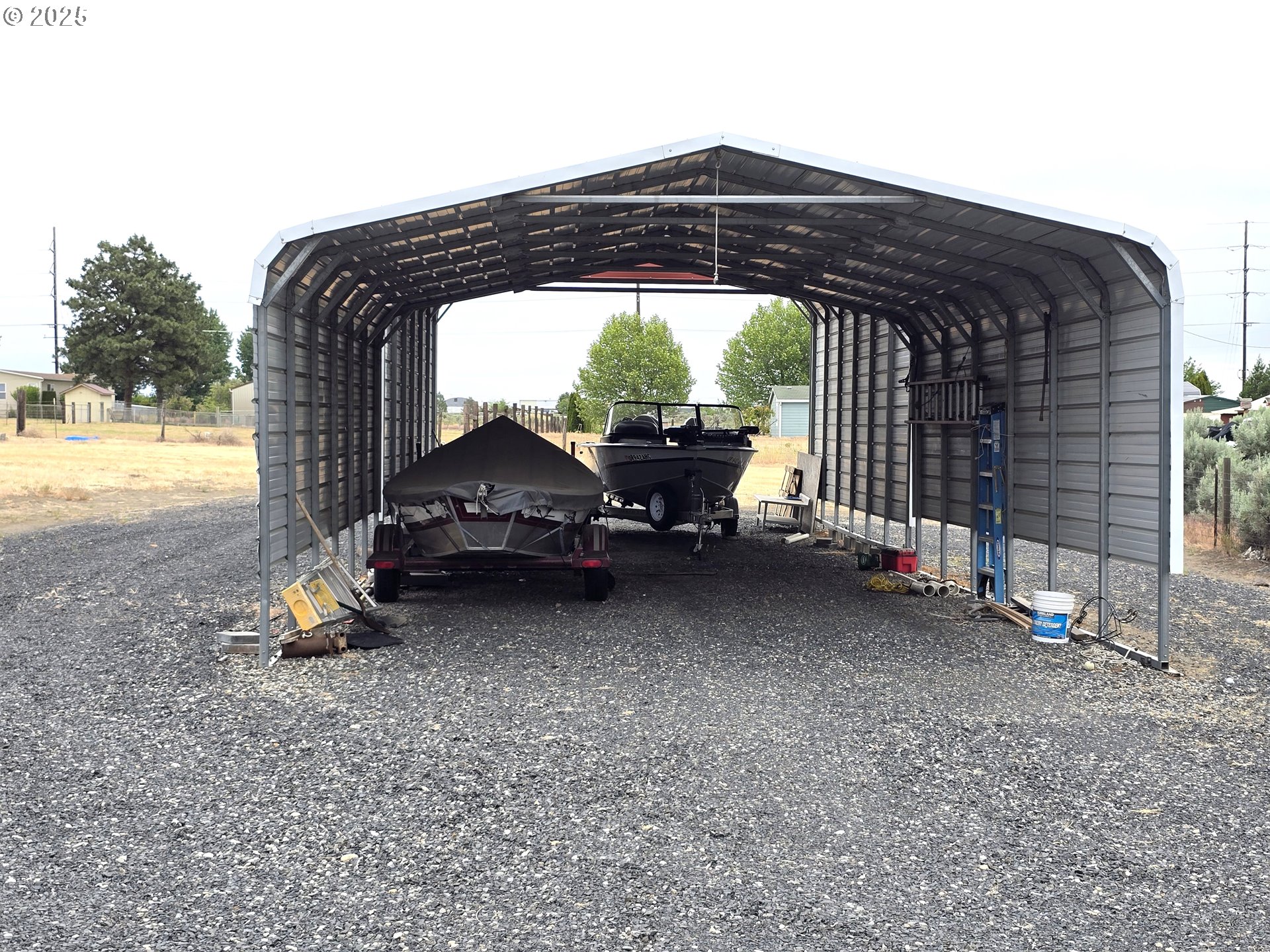 80393 Zimmer Lane Hermiston, OR 97838 - Photo 45 of 46 a backyard of a house with barbeque oven table and chairs