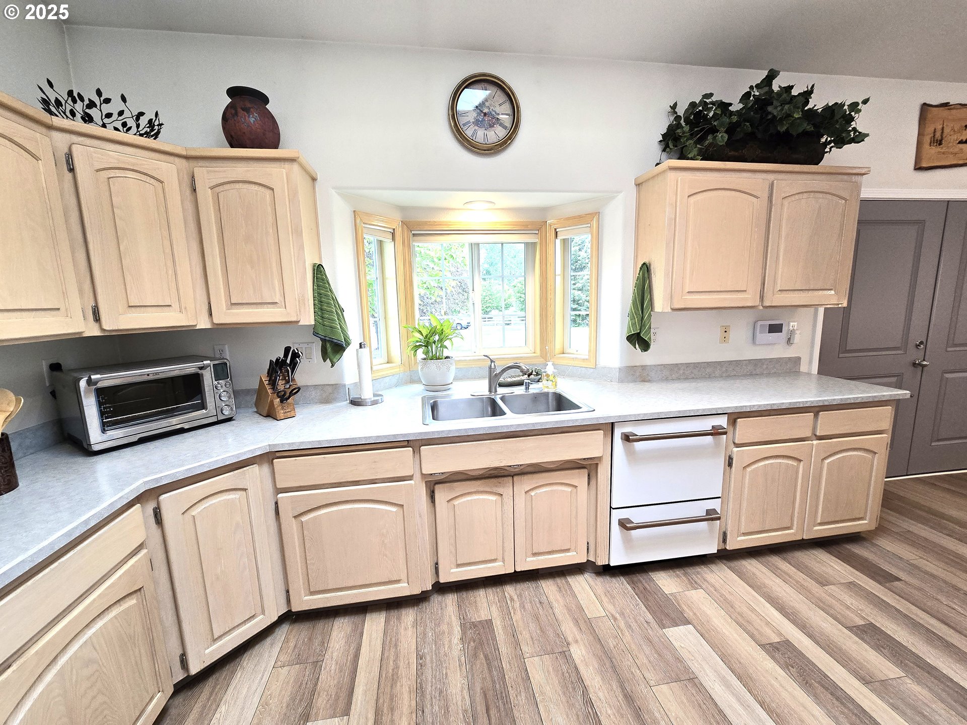 80393 Zimmer Lane Hermiston, OR 97838 - Photo 10 of 46 a white kitchen with stainless steel appliances granite countertop a sink dishwasher a stove and white cabinets with wooden floor