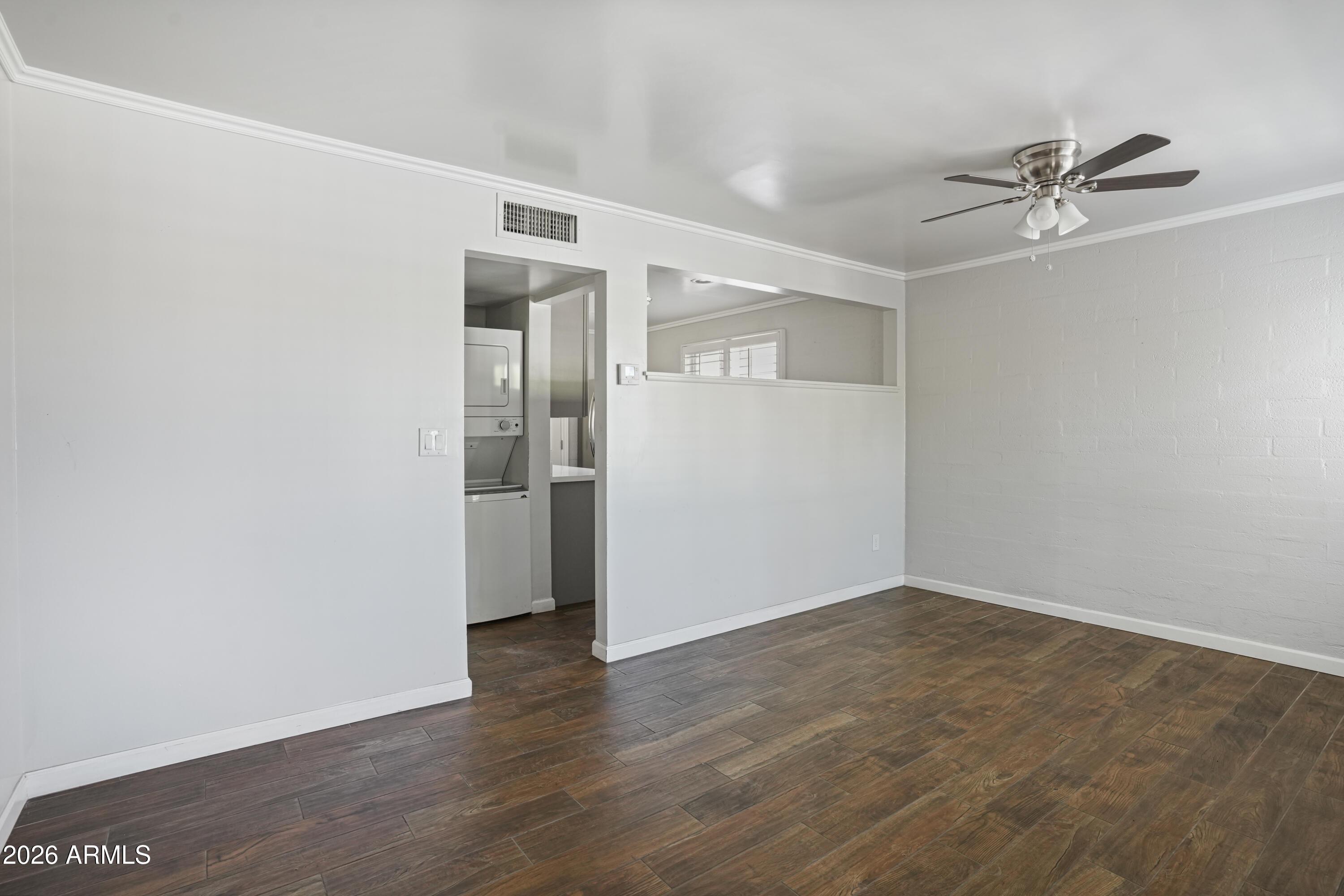 3426 North Miller Road, Unit 8 Scottsdale, AZ 85251 - Photo 2 of 10 a view of a big room with wooden floor and closet