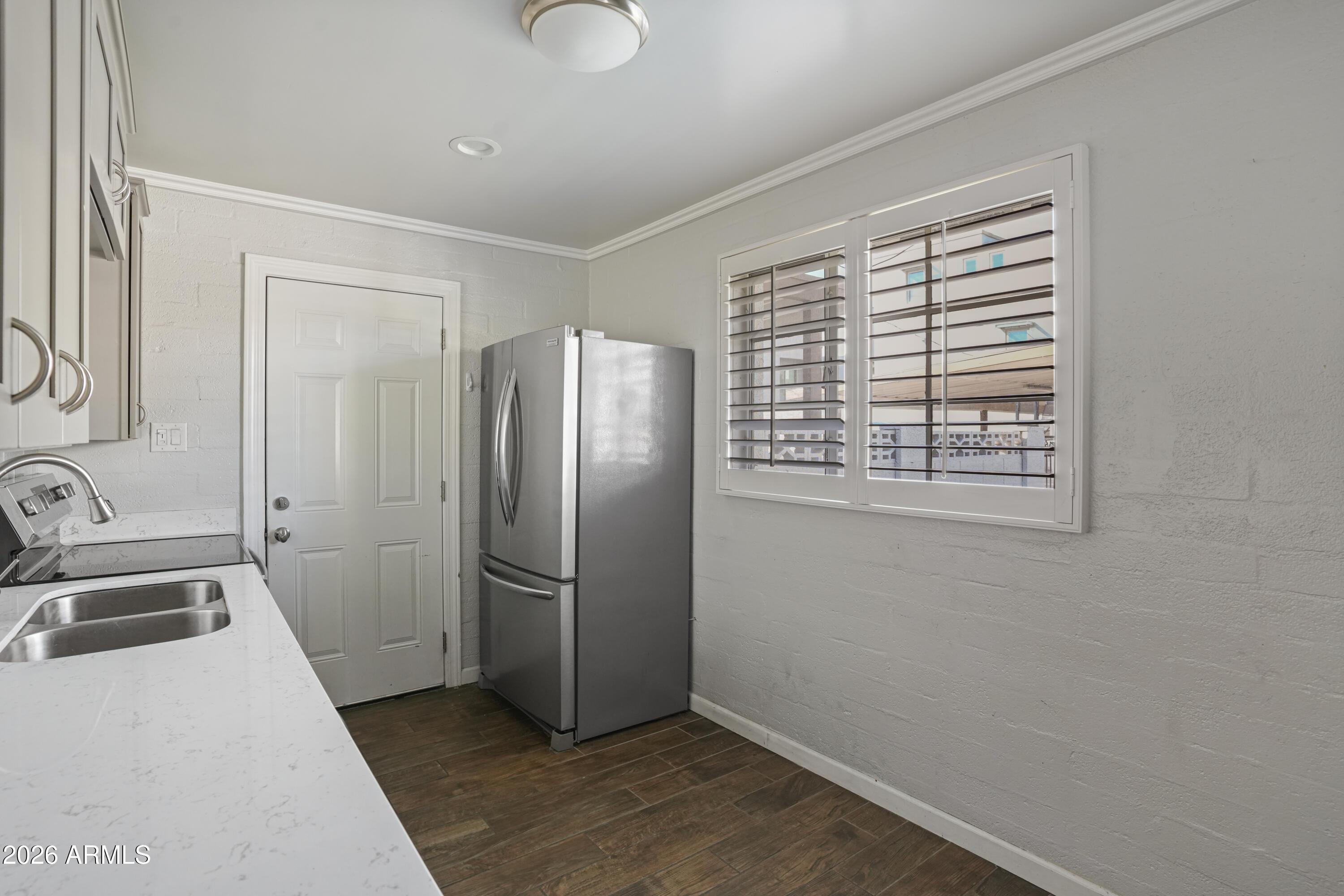3426 North Miller Road, Unit 8 Scottsdale, AZ 85251 - Photo 7 of 10 a kitchen with a refrigerator and a sink