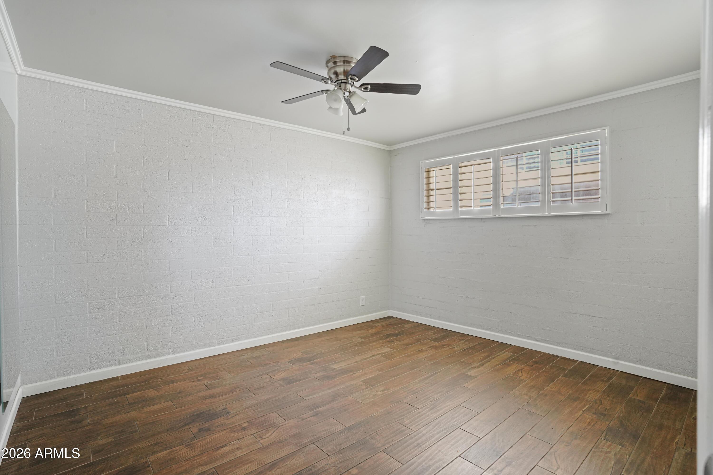 3426 North Miller Road, Unit 8 Scottsdale, AZ 85251 - Photo 10 of 10 wooden floor in an empty room with a window