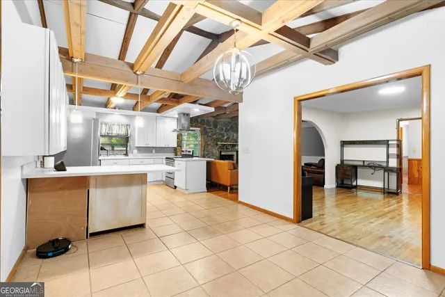 a large white kitchen with a sink and cabinets