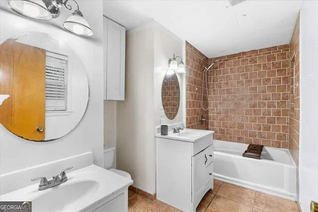 a bathroom with a sink mirror and tub