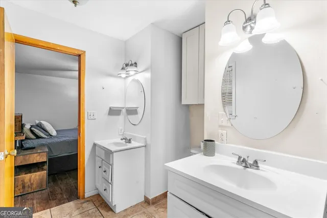 a en suite bathroom with a sink double vanity and a mirror