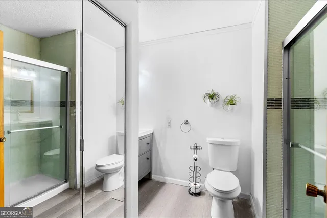 a white toilet sitting next to a bathroom sink