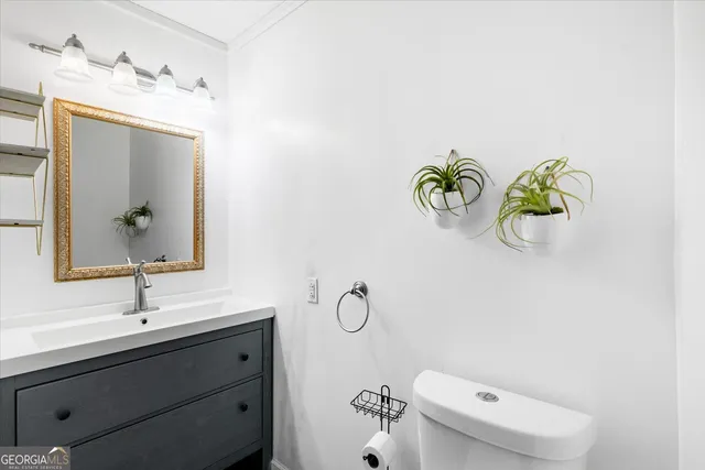 a bathroom with a sink toilet and mirror