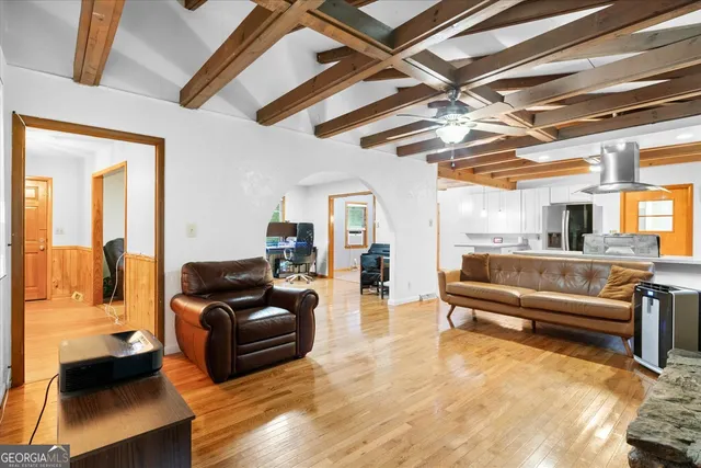 a living room with furniture and a chandelier