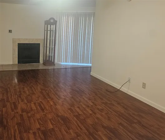 a view of wooden floor and windows in a room