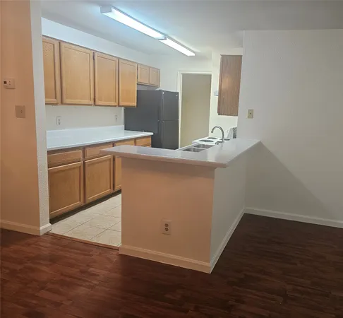 a kitchen with stainless steel appliances granite countertop a sink refrigerator and microwave