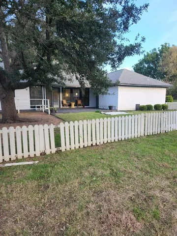 a view of a house with wooden fence
